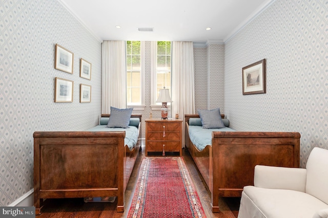 bedroom with ornamental molding and dark hardwood / wood-style floors