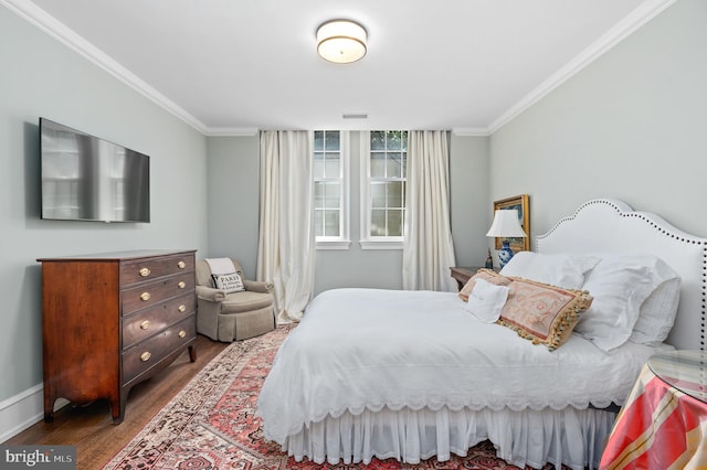 bedroom featuring hardwood / wood-style flooring and crown molding