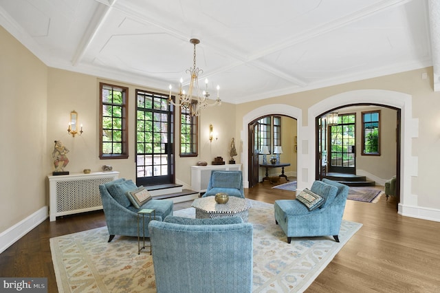 sitting room featuring coffered ceiling, hardwood / wood-style floors, and an inviting chandelier