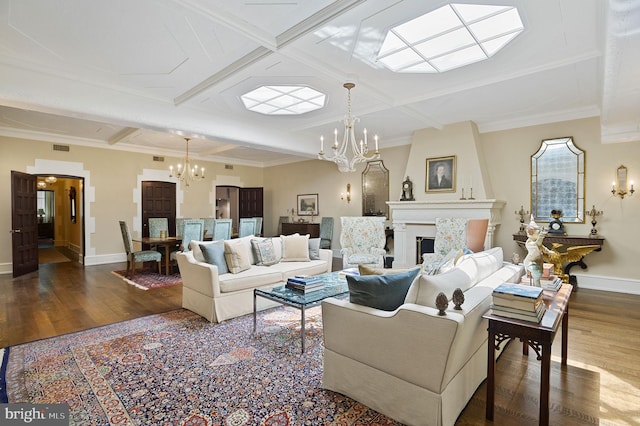 living room featuring hardwood / wood-style flooring, coffered ceiling, and an inviting chandelier