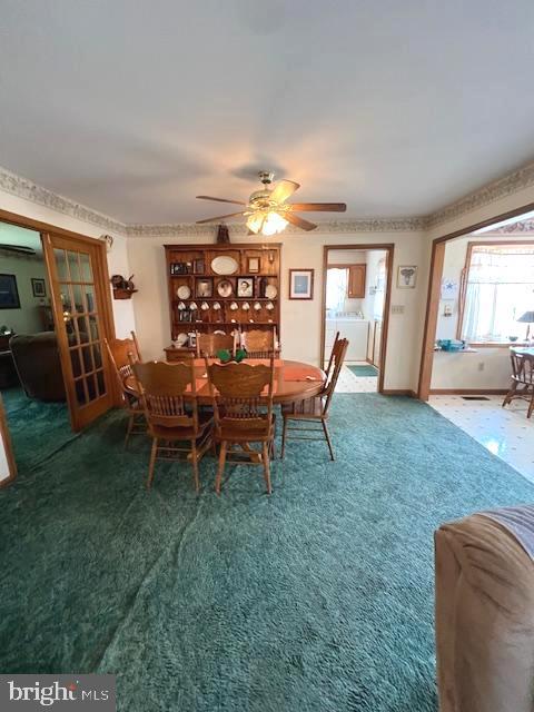 carpeted dining space with ceiling fan and a wall unit AC