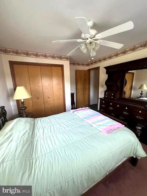 carpeted bedroom with ceiling fan