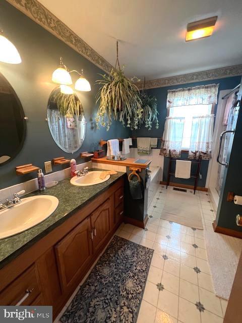 bathroom with vanity and a tub