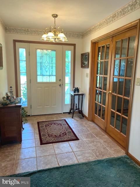 tiled foyer with a notable chandelier