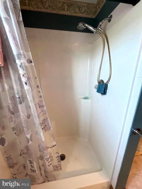 bathroom with a shower with shower curtain