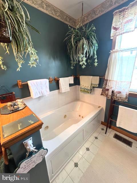 bathroom featuring tile patterned flooring and a tub