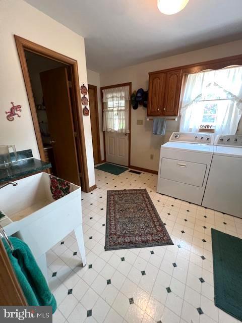 washroom featuring washing machine and dryer and a wealth of natural light