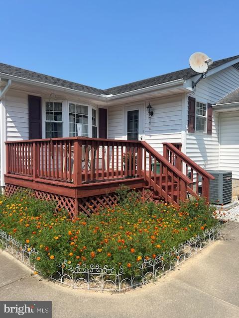 wooden deck with central air condition unit