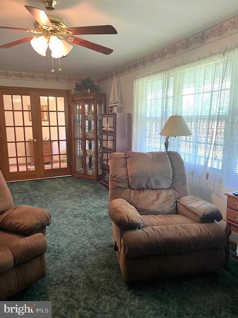 sitting room with french doors and carpet flooring