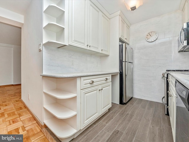 kitchen featuring white cabinets, stainless steel appliances, parquet floors, and open shelves