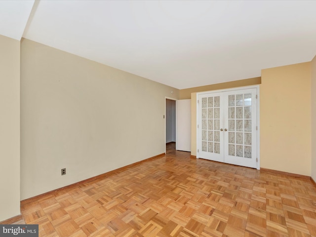 empty room with baseboards and french doors