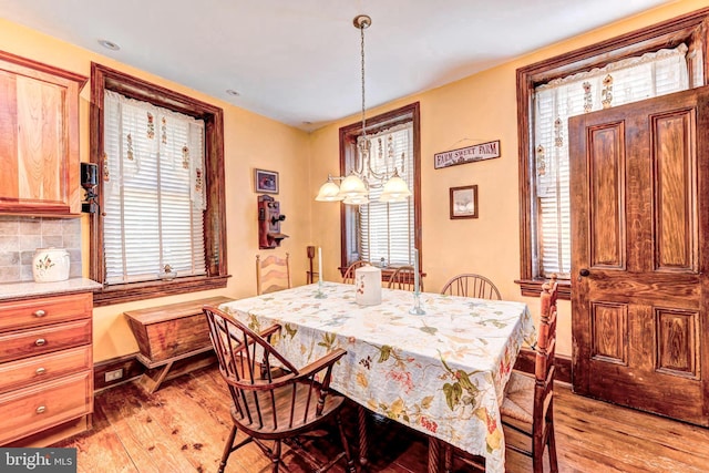 dining area with light wood-type flooring and plenty of natural light