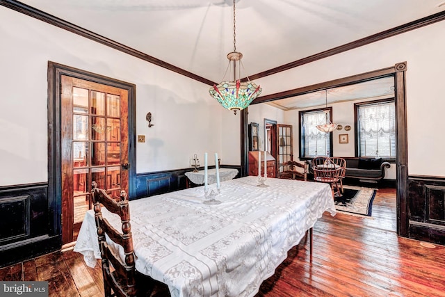 dining space featuring crown molding and dark hardwood / wood-style flooring