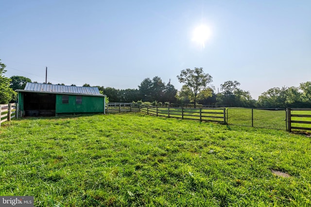 view of yard featuring an outbuilding and a rural view