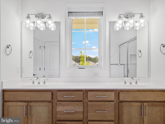 bathroom featuring vanity and a shower with door