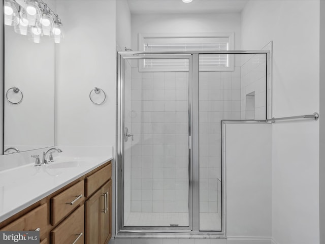 bathroom with vanity and a shower with shower door