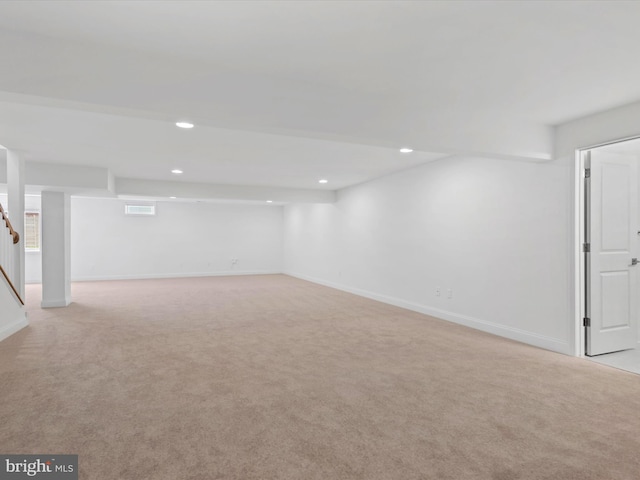 basement featuring light colored carpet