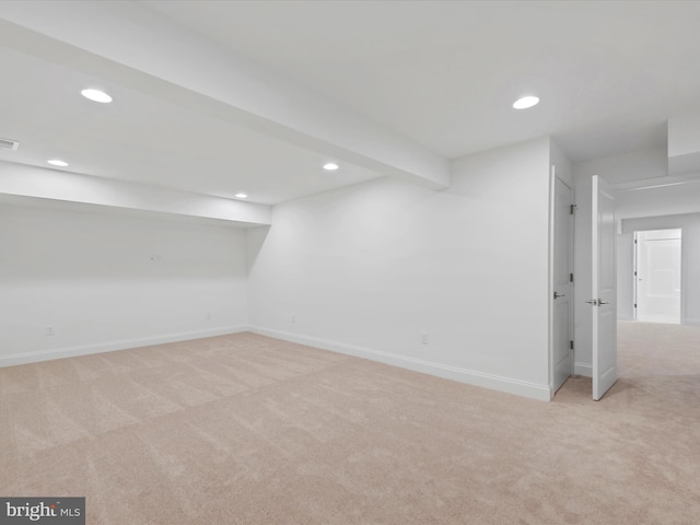 basement featuring light colored carpet