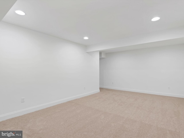 basement featuring light carpet