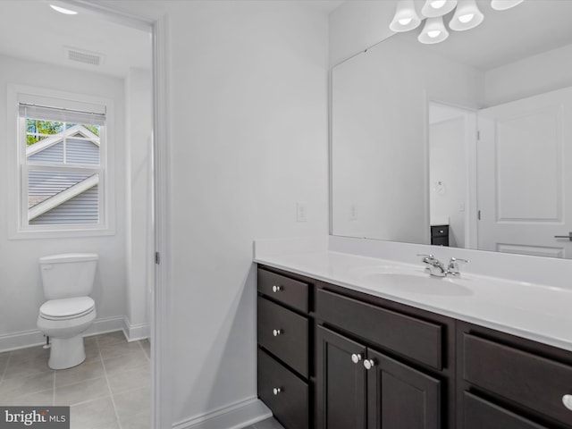 bathroom featuring vanity, toilet, and tile patterned flooring