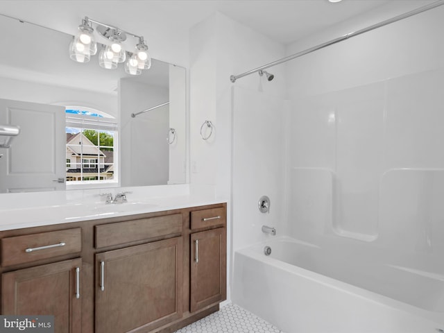 bathroom featuring tile patterned flooring, vanity, and  shower combination