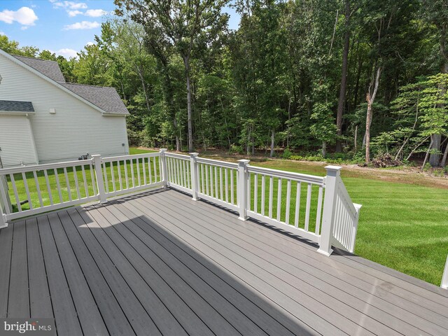 wooden deck with a lawn