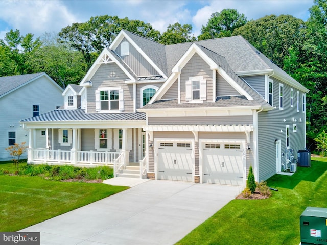 craftsman house featuring cooling unit, a porch, a garage, and a front yard