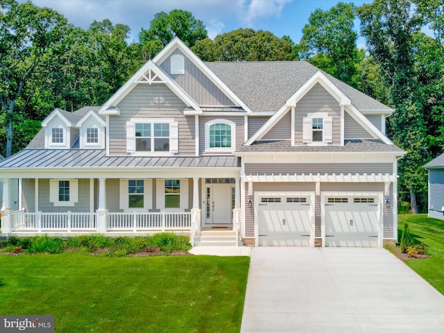 view of front facade featuring a garage, a front yard, and covered porch