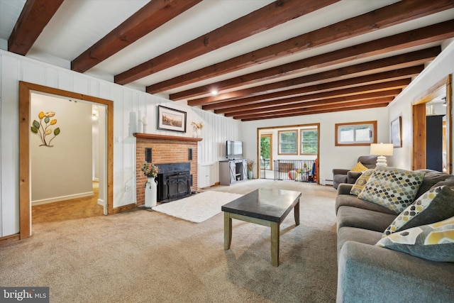 living room featuring a baseboard radiator, a brick fireplace, carpet, and beamed ceiling