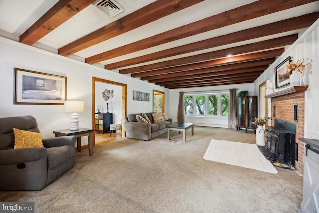 carpeted living room with beamed ceiling and a fireplace