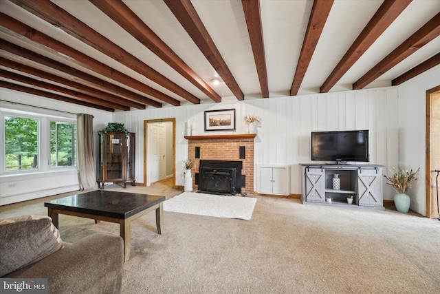 unfurnished living room with beamed ceiling, carpet floors, and a fireplace