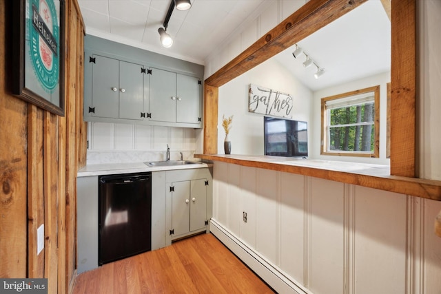 kitchen featuring black dishwasher, sink, vaulted ceiling, rail lighting, and light hardwood / wood-style flooring