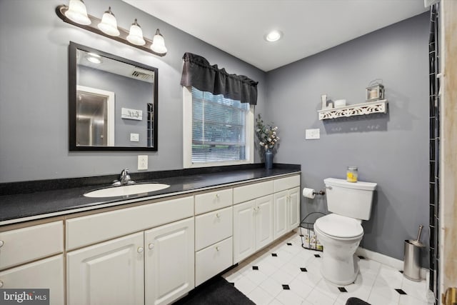 bathroom with vanity, toilet, and tile patterned floors