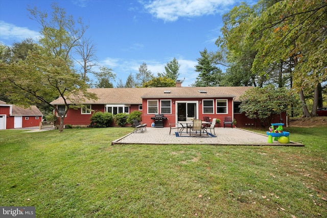 rear view of property featuring a patio area and a yard