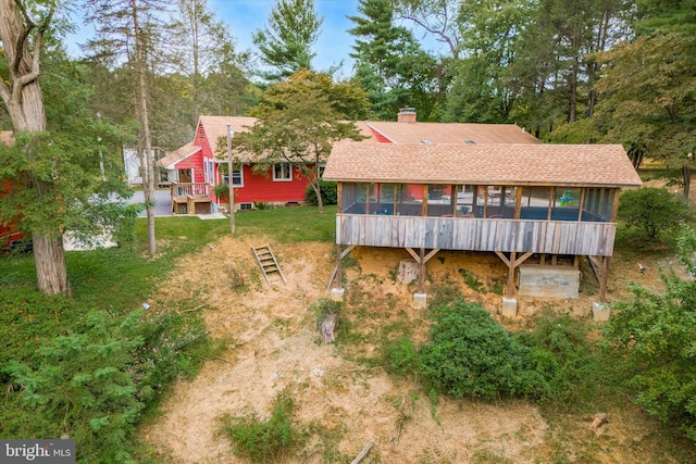 back of house featuring a sunroom