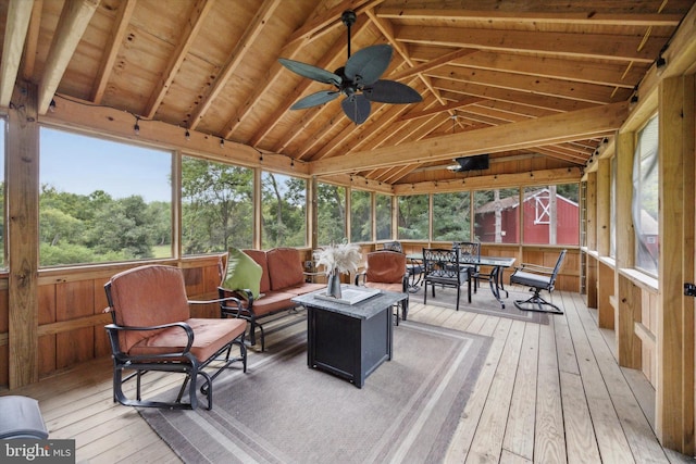 sunroom with vaulted ceiling with beams, ceiling fan, and plenty of natural light