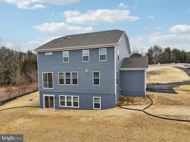 back of property featuring a lawn