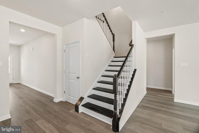 stairway with hardwood / wood-style floors