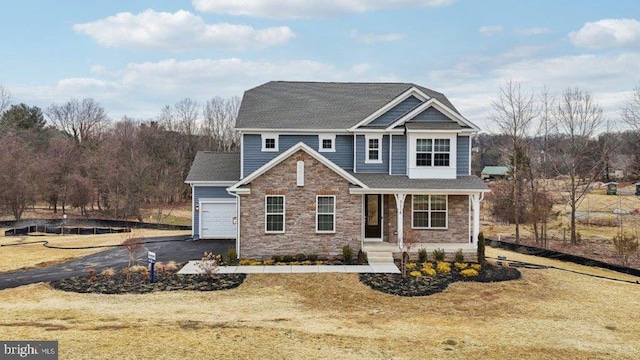 view of front facade with a garage and a front lawn