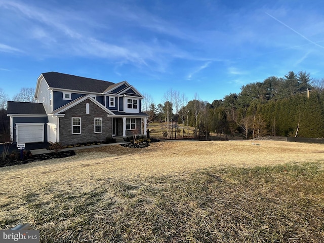 view of front of property featuring a garage and a front yard