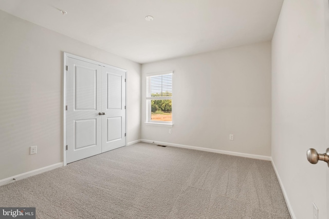 unfurnished bedroom with carpet and a closet