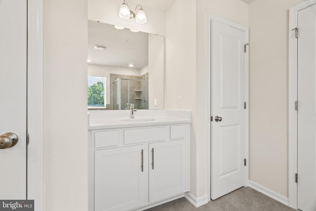 bathroom featuring vanity and a shower with shower door