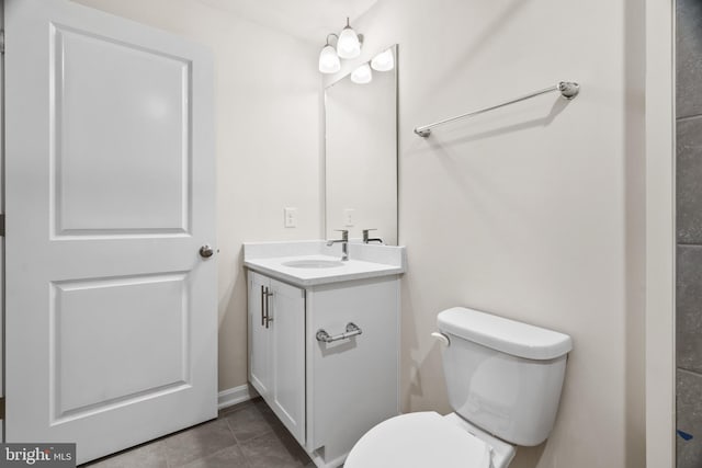 bathroom featuring vanity, tile patterned floors, and toilet