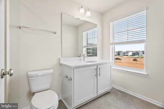 bathroom with vanity, tile patterned flooring, and toilet