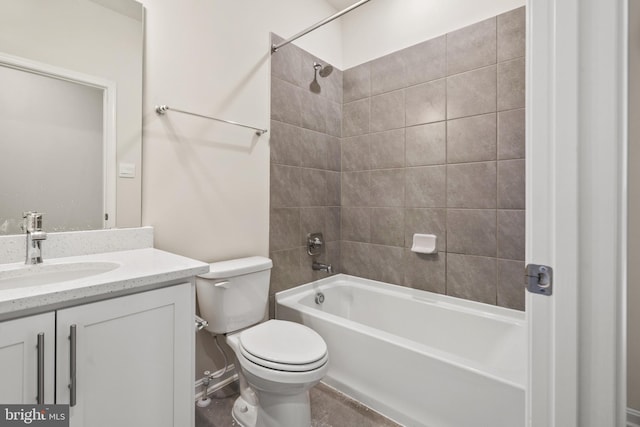 full bathroom with vanity, tiled shower / bath combo, and toilet