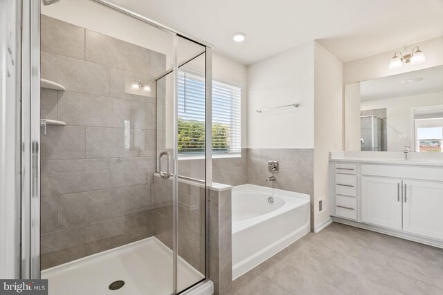 bathroom with vanity, independent shower and bath, and tile patterned flooring