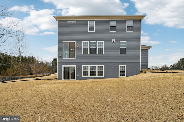 rear view of house with a yard