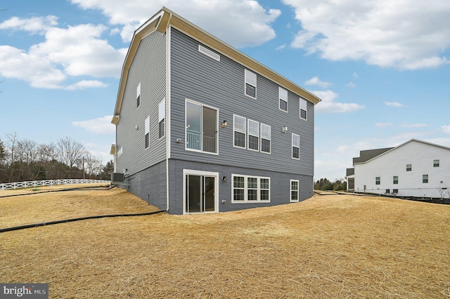 rear view of house with a yard