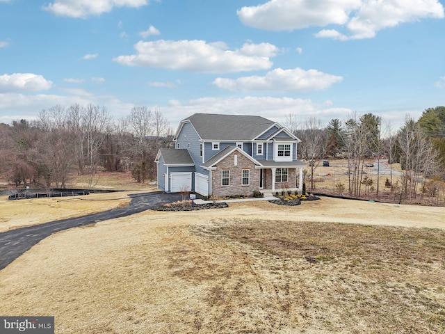 front of property with a garage and a front yard