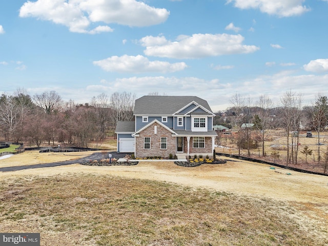 view of front property featuring a garage and a front yard